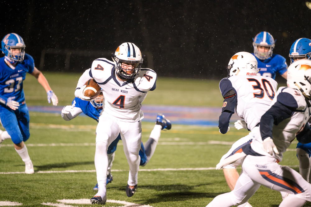 Briar Woods junior running back Evan Rutkowski breaks free from a tackle