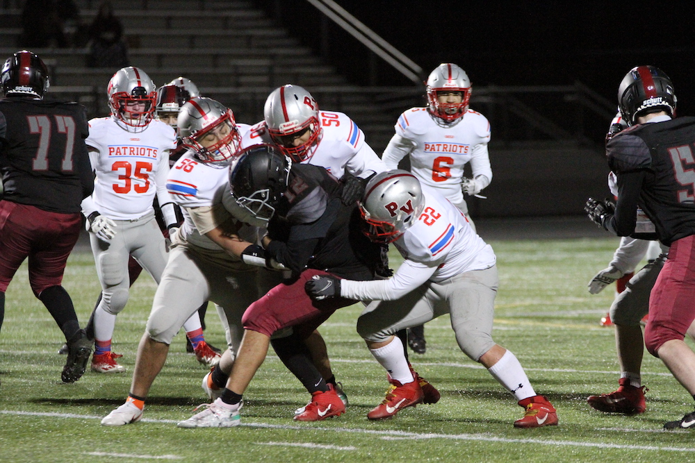 Park View's Atif Aslam, Caleb Park, and Derek Ramirez make a group tackle in their win over Rock Ridge on March 19